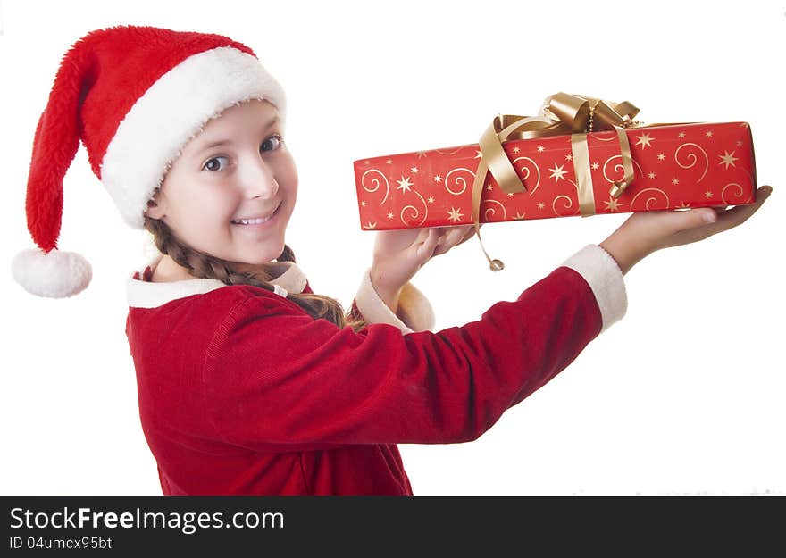Beautiful girl dressed in Christmas clothes and red santa hat with present in her hands isolated on white background. Beautiful girl dressed in Christmas clothes and red santa hat with present in her hands isolated on white background