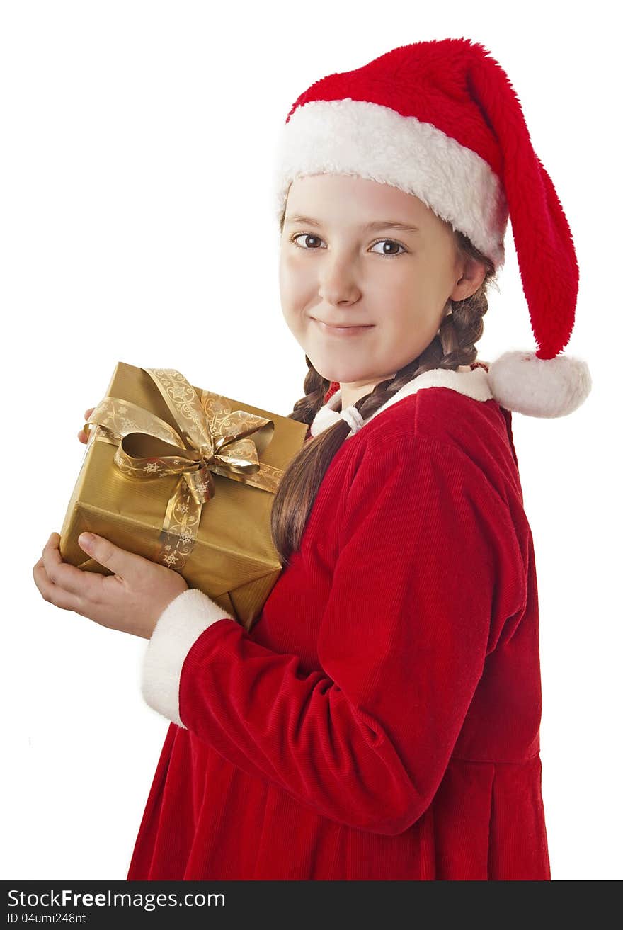 Beautiful girl dressed in Christmas clothes and red santa hat with present in her hands isolated on white background. Beautiful girl dressed in Christmas clothes and red santa hat with present in her hands isolated on white background