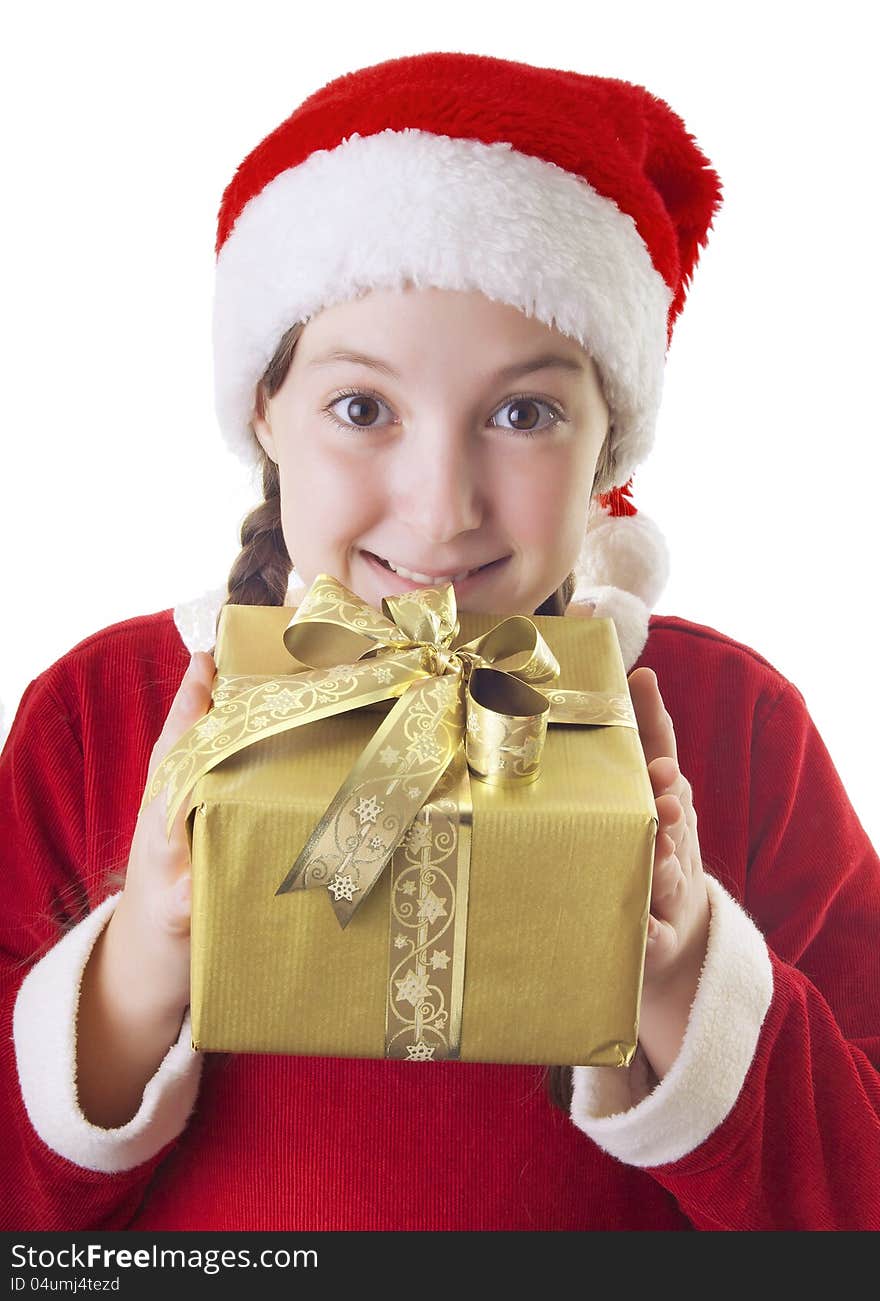 Beautiful girl dressed in Christmas clothes and red santa hat with present in her hands isolated on white background. Beautiful girl dressed in Christmas clothes and red santa hat with present in her hands isolated on white background