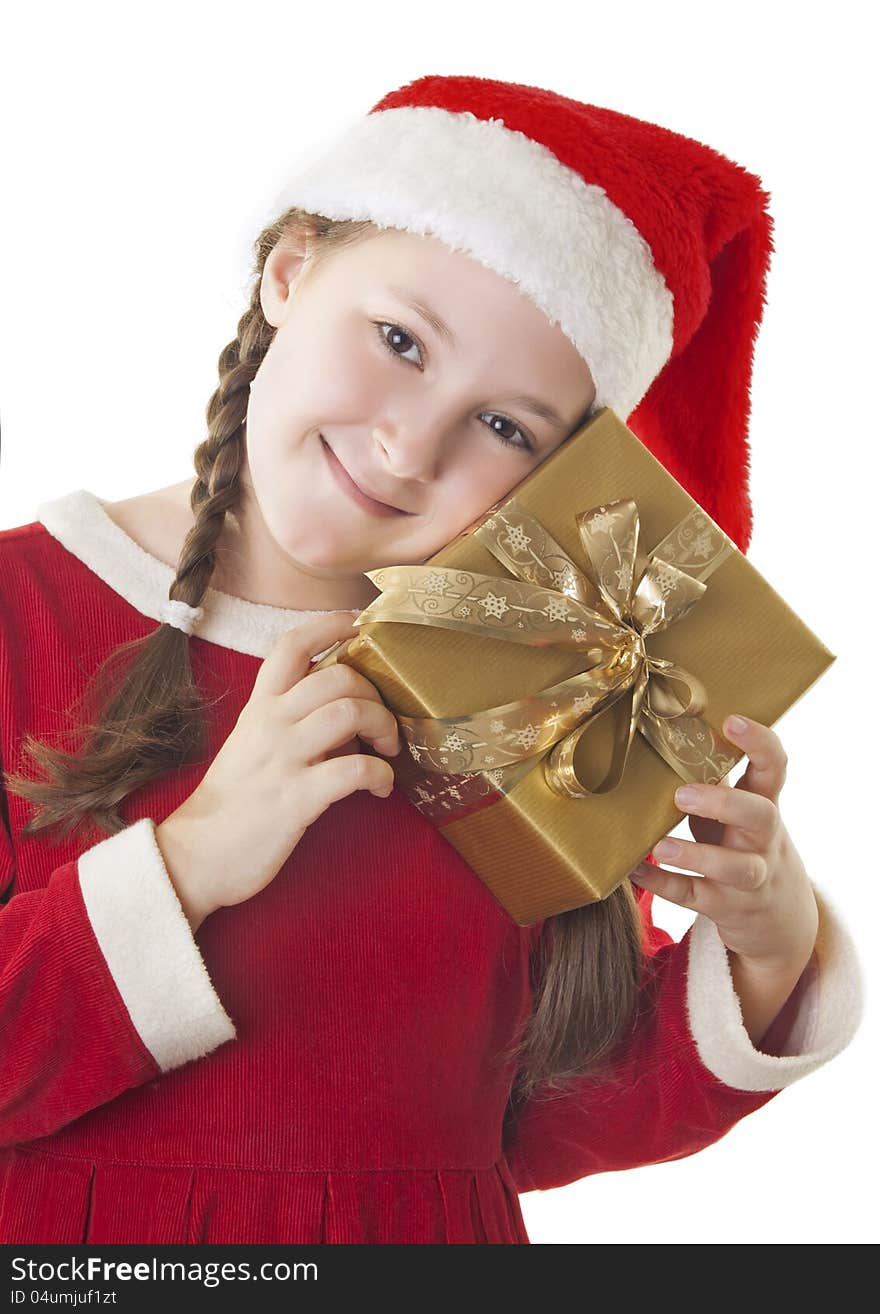 Beautiful girl dressed in Christmas clothes and red santa hat with present in her hands isolated on white background. Beautiful girl dressed in Christmas clothes and red santa hat with present in her hands isolated on white background