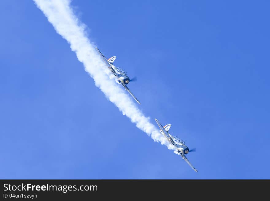 Two propeller aircrafts displaying acrobatics in Bucharest, Romania. Two propeller aircrafts displaying acrobatics in Bucharest, Romania