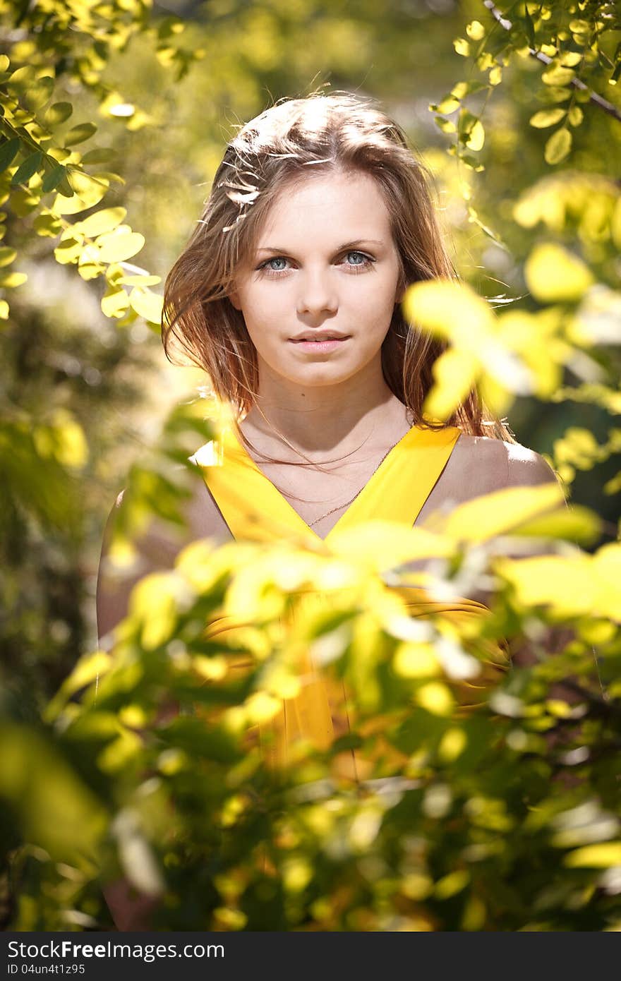 Beautiful Girl In A Yellow Dress On The Nature