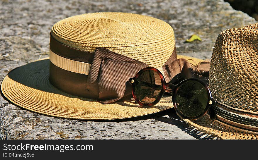 Elegant straw hat and designer glasses