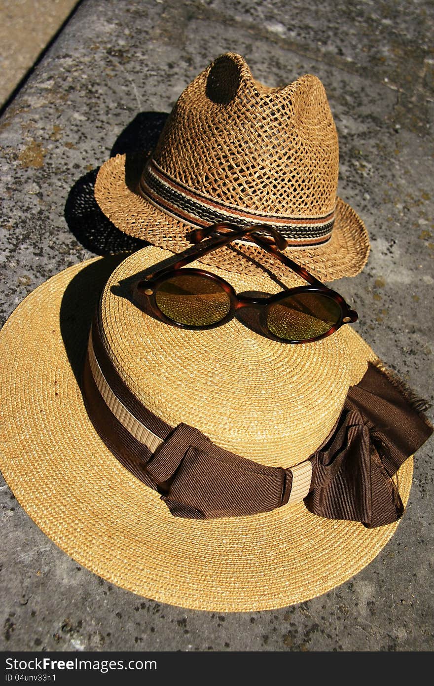 Elegant straw hat and designer glasses