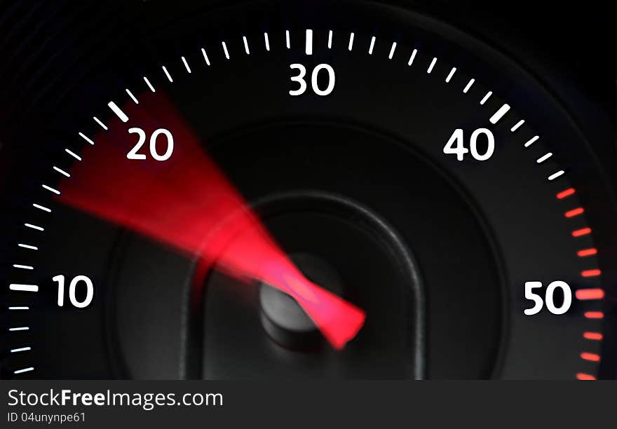 Rev-counter gauge (tachometer) of a diesel engine at night, indicating a range of fuel-saving low rotation speeds with a red needle. Rev-counter gauge (tachometer) of a diesel engine at night, indicating a range of fuel-saving low rotation speeds with a red needle