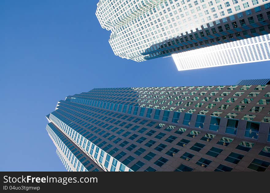 Two isolated  skyscrapers on a background of clear blue sky.