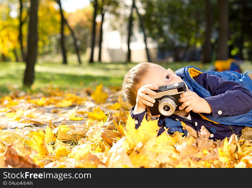 Small boy playing with a slr camera