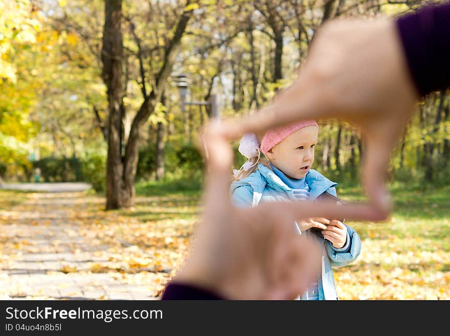 Little girl seen through a finger frame