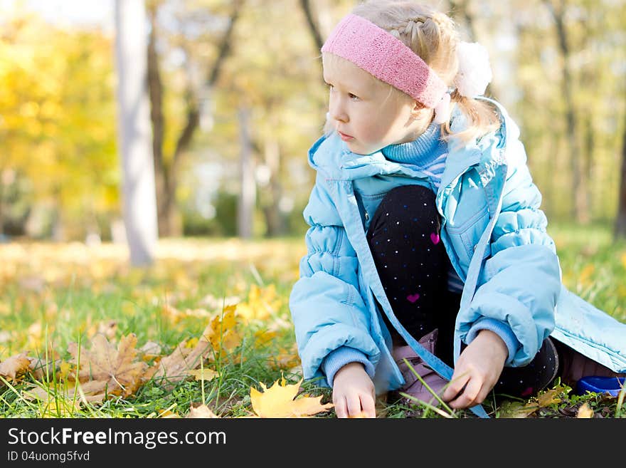 Young Girl Sitting In A Park