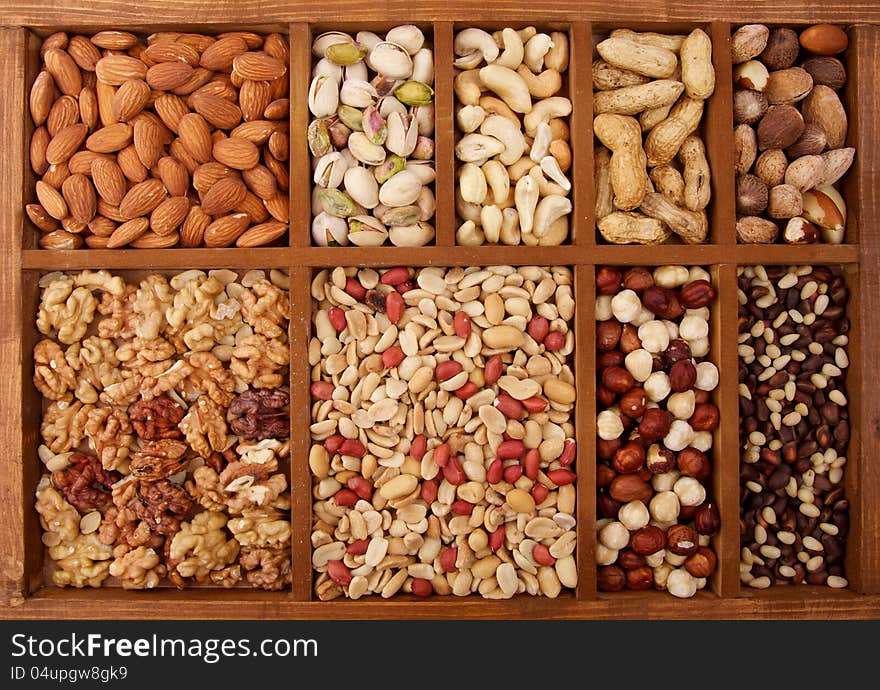 Background of Various Nuts in Wooden Box closeup. Background of Various Nuts in Wooden Box closeup