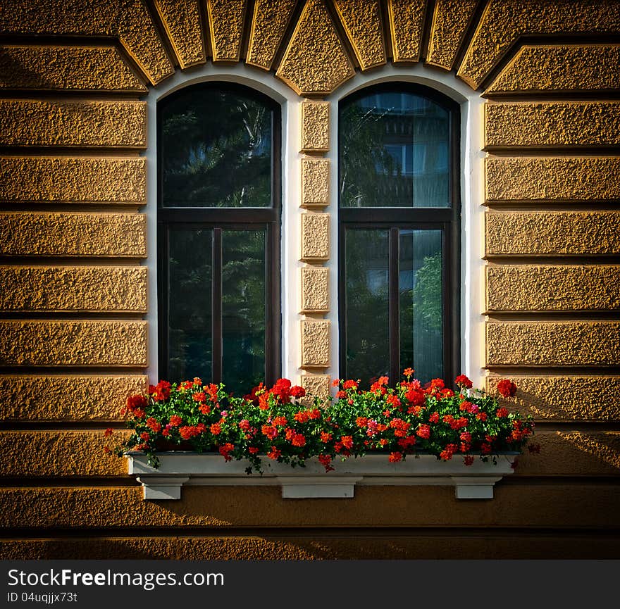 Red flowers in window boxes. Red flowers in window boxes.