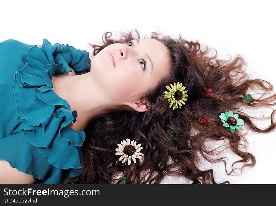 Portrait of pretty brunette girl posing with long curly hair