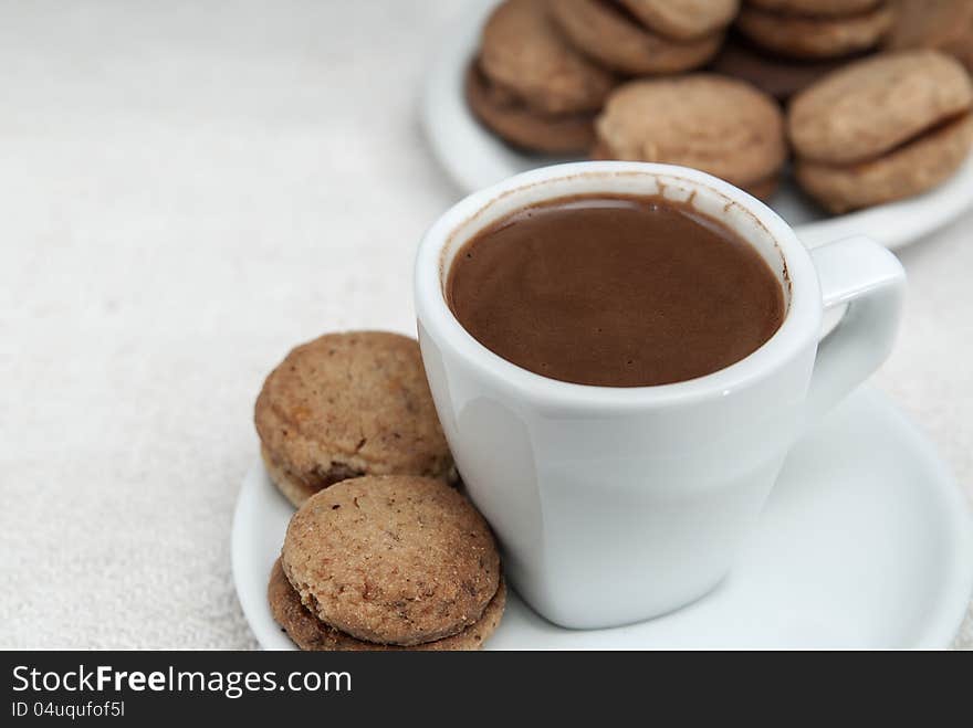 Close up photo of walnut cookies and coffee on table