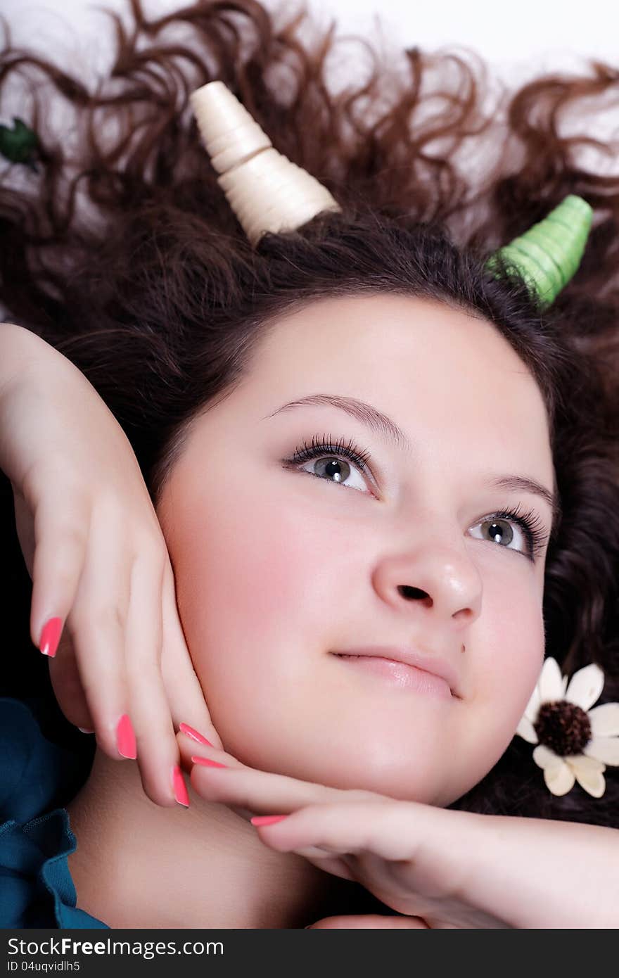 Portrait of pretty brunette with horns long curly hair