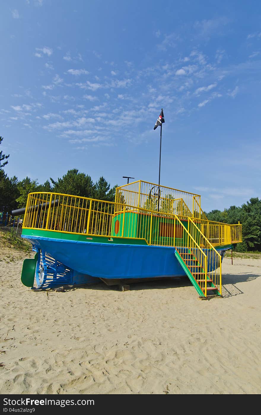 A tugboat converted into a playground pirate ship with pirate flag for children. A tugboat converted into a playground pirate ship with pirate flag for children.