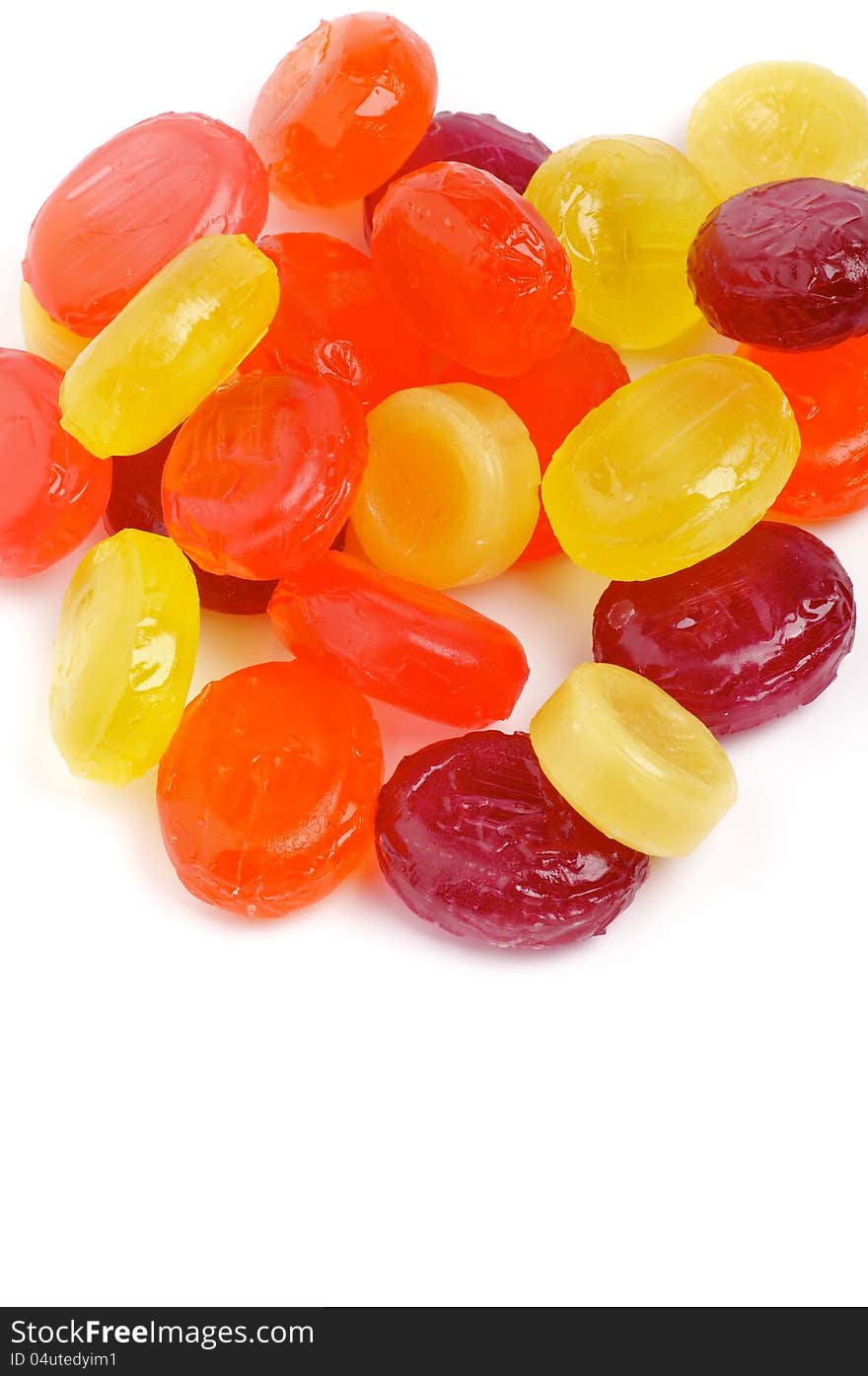 Heap of Multi Coloured Fruit Drops on white background