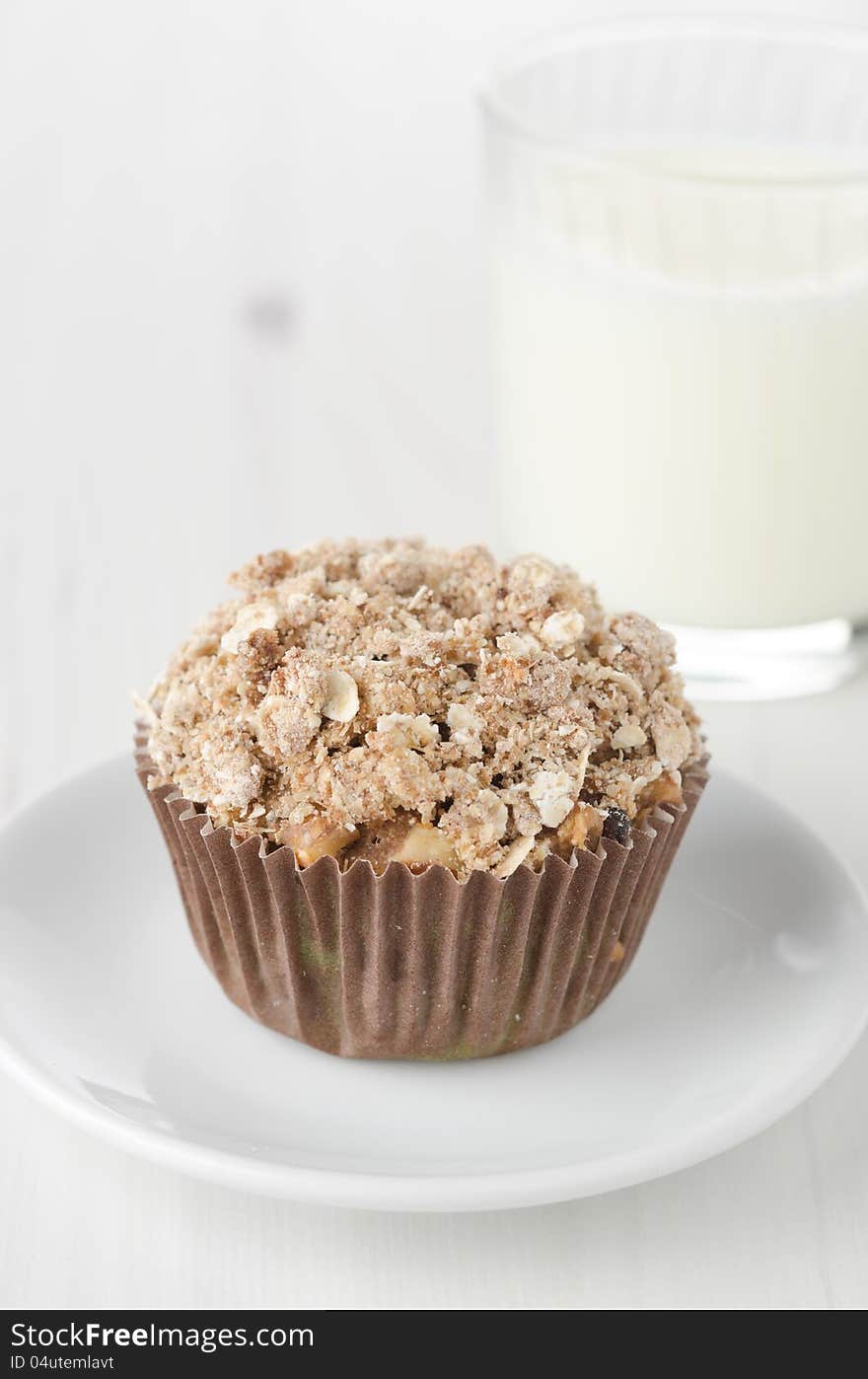 Muffin with apple and crumble topping of oatmeal in paper molds. Muffin with apple and crumble topping of oatmeal in paper molds