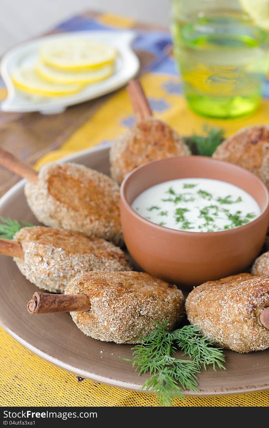 Chicken cutlets on a stick of cinnamon