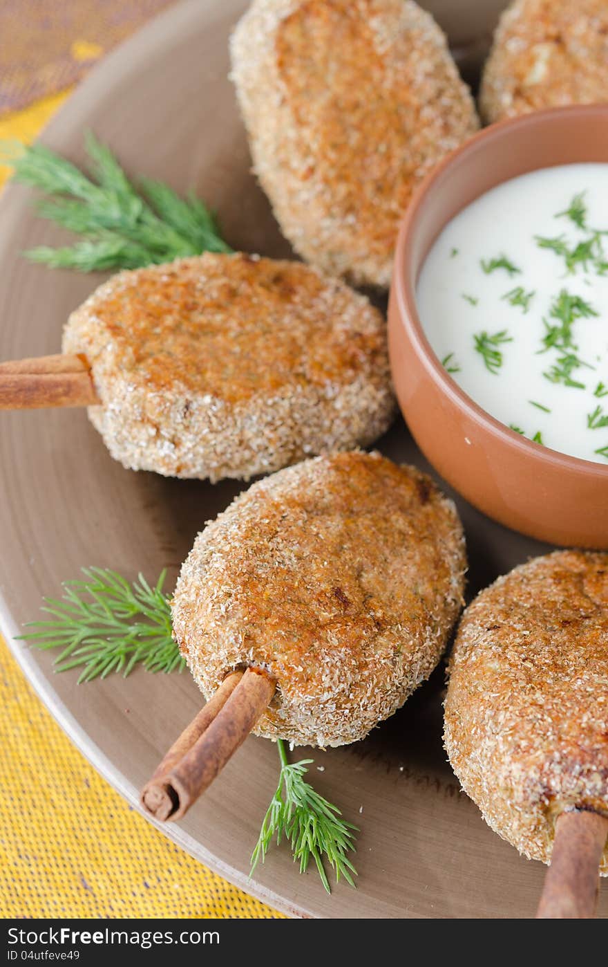 Chicken cutlets on a stick of cinnamon