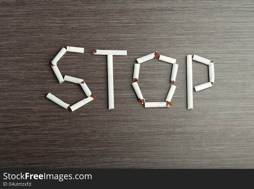 Concept of the dangers of smoking. the word stop of cigarettes. Concept of the dangers of smoking. the word stop of cigarettes