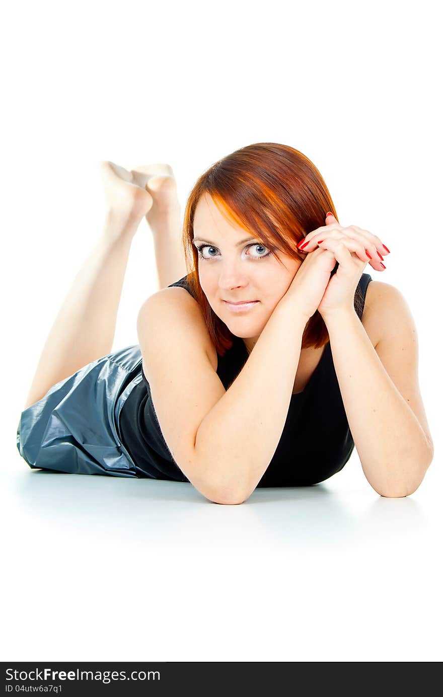 Happy redhead girl lies on a white background