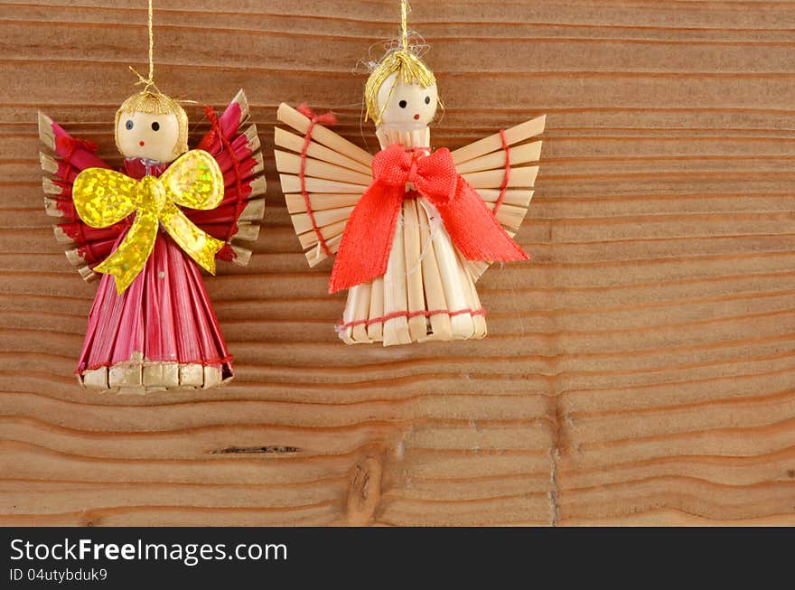 Christmas decoration - two angels on wood background