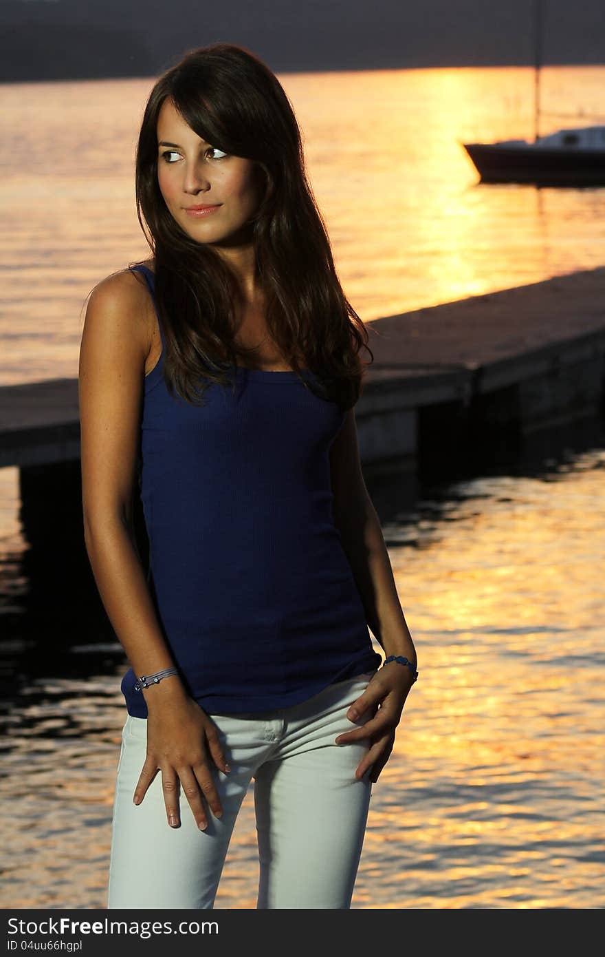 Beautiful outdoor portrait of a young girl in sunset light by the lake. Beautiful outdoor portrait of a young girl in sunset light by the lake