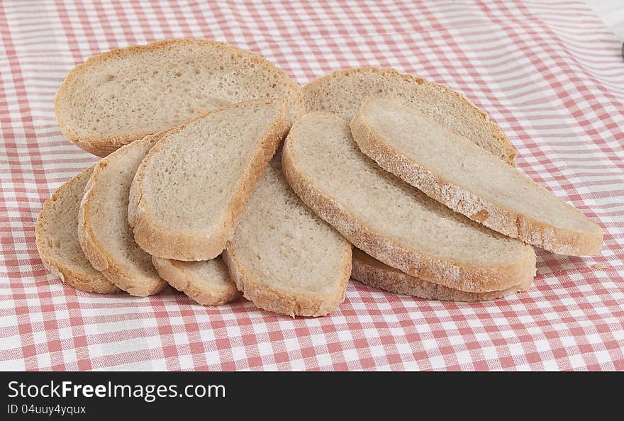 The gray bread cut on pieces on a pink napkin