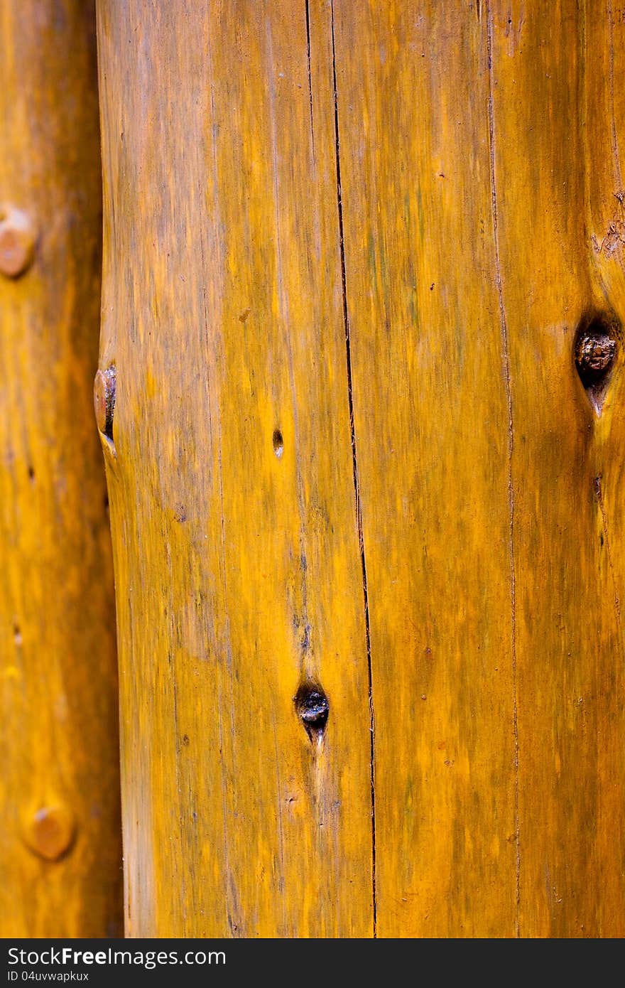 A background of wood grain creates a texture image in brown yellow. This is pine or fir in a vertical orientation. A background of wood grain creates a texture image in brown yellow. This is pine or fir in a vertical orientation.