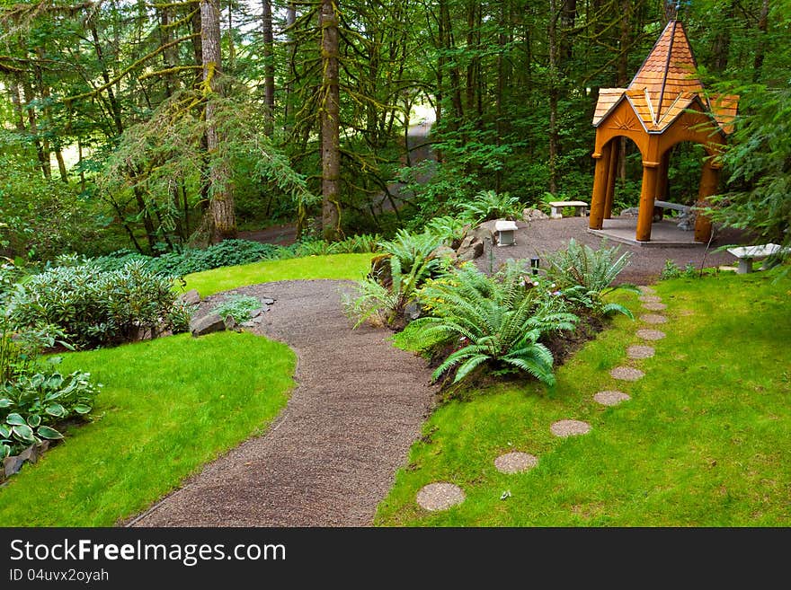 A beautiful path leads to a wooden gazebo in a perfectly manicured green natural garden at an Oregon wedding venue. A beautiful path leads to a wooden gazebo in a perfectly manicured green natural garden at an Oregon wedding venue.