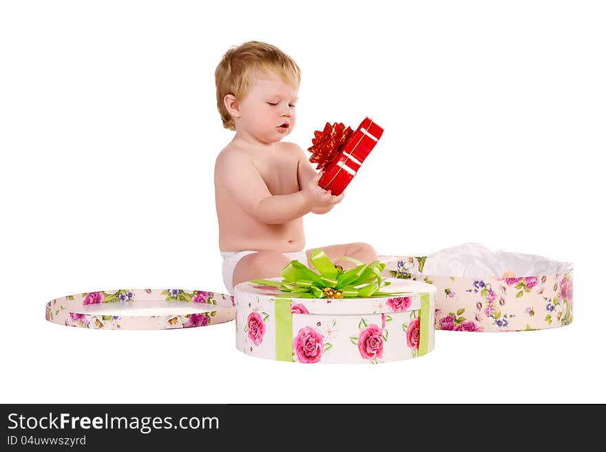 Boy plays with gift boxes isolated on white background