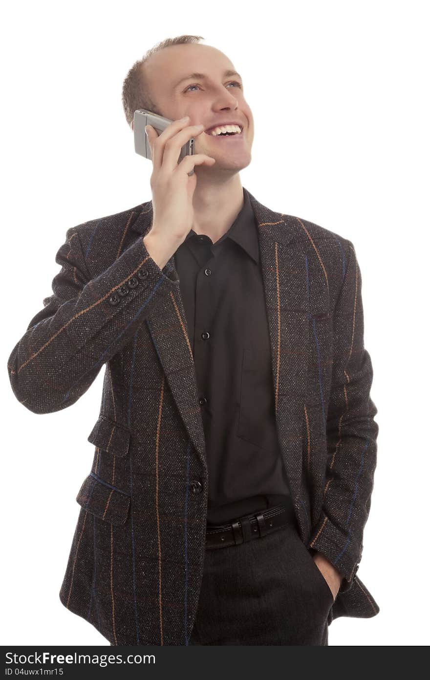 Young man speaking on cellphone and looking against white background. Young man speaking on cellphone and looking against white background