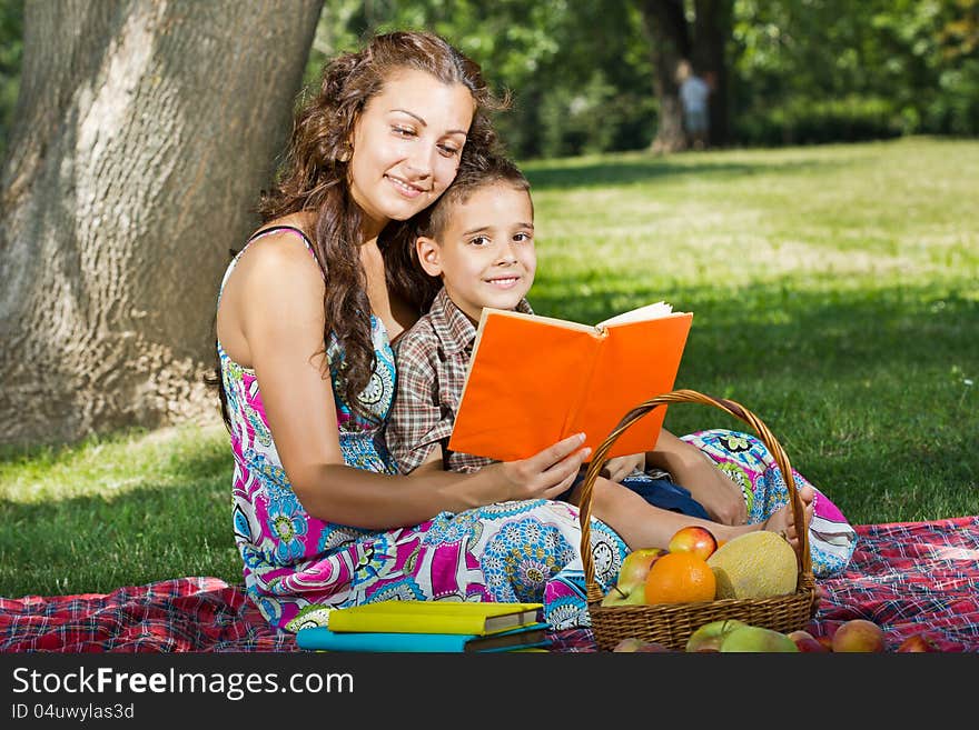 Mother and little boy reading book together