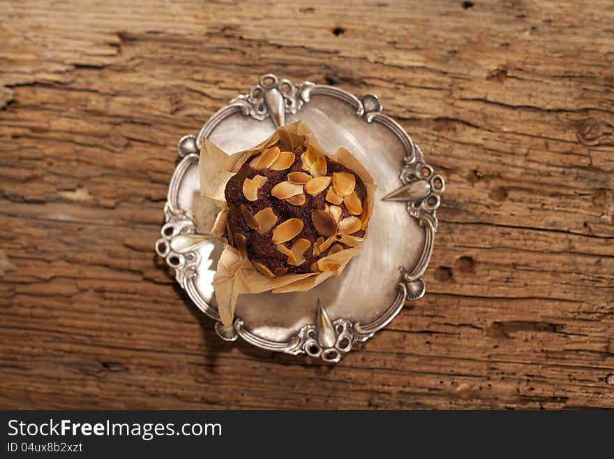 Peanuts with delicious muffin on silver plate. Peanuts with delicious muffin on silver plate