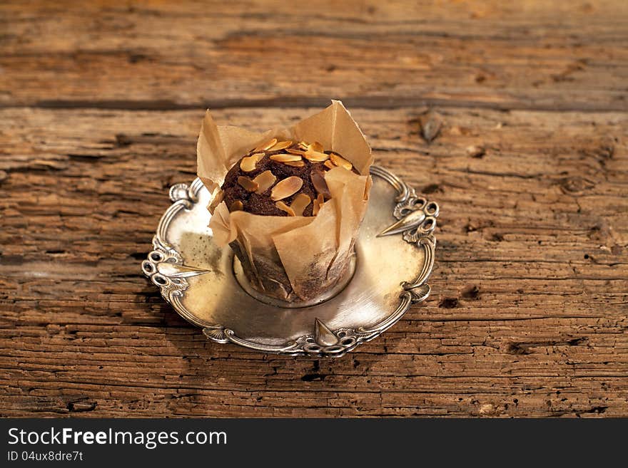 Peanuts with delicious muffin on silver plate. Peanuts with delicious muffin on silver plate