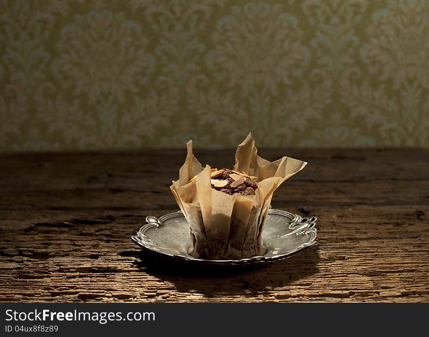 Peanuts with delicious muffin on silver plate