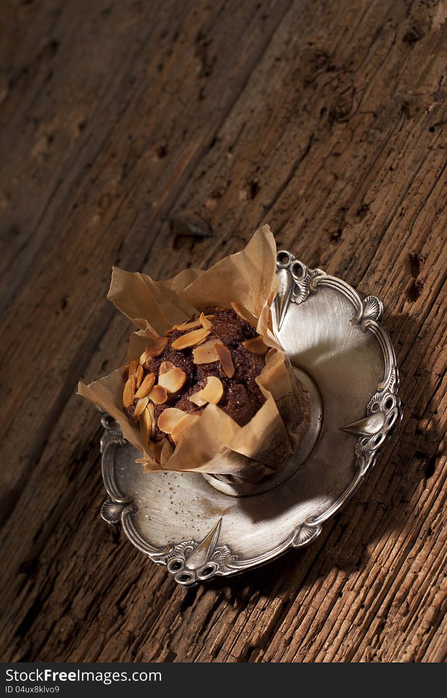 Peanuts with delicious muffin on silver plate. Peanuts with delicious muffin on silver plate