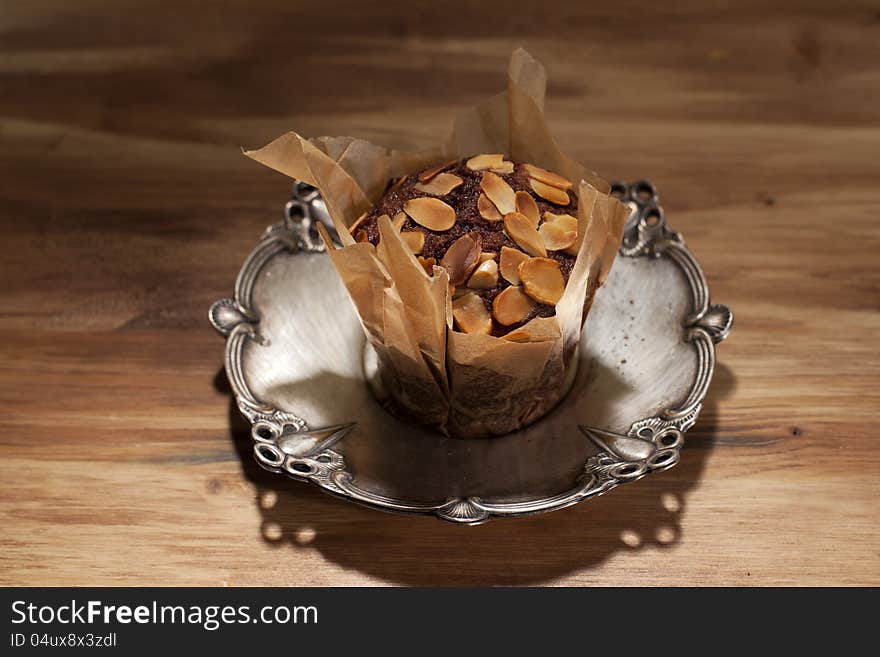 Peanuts with delicious muffin on silver plate. Peanuts with delicious muffin on silver plate