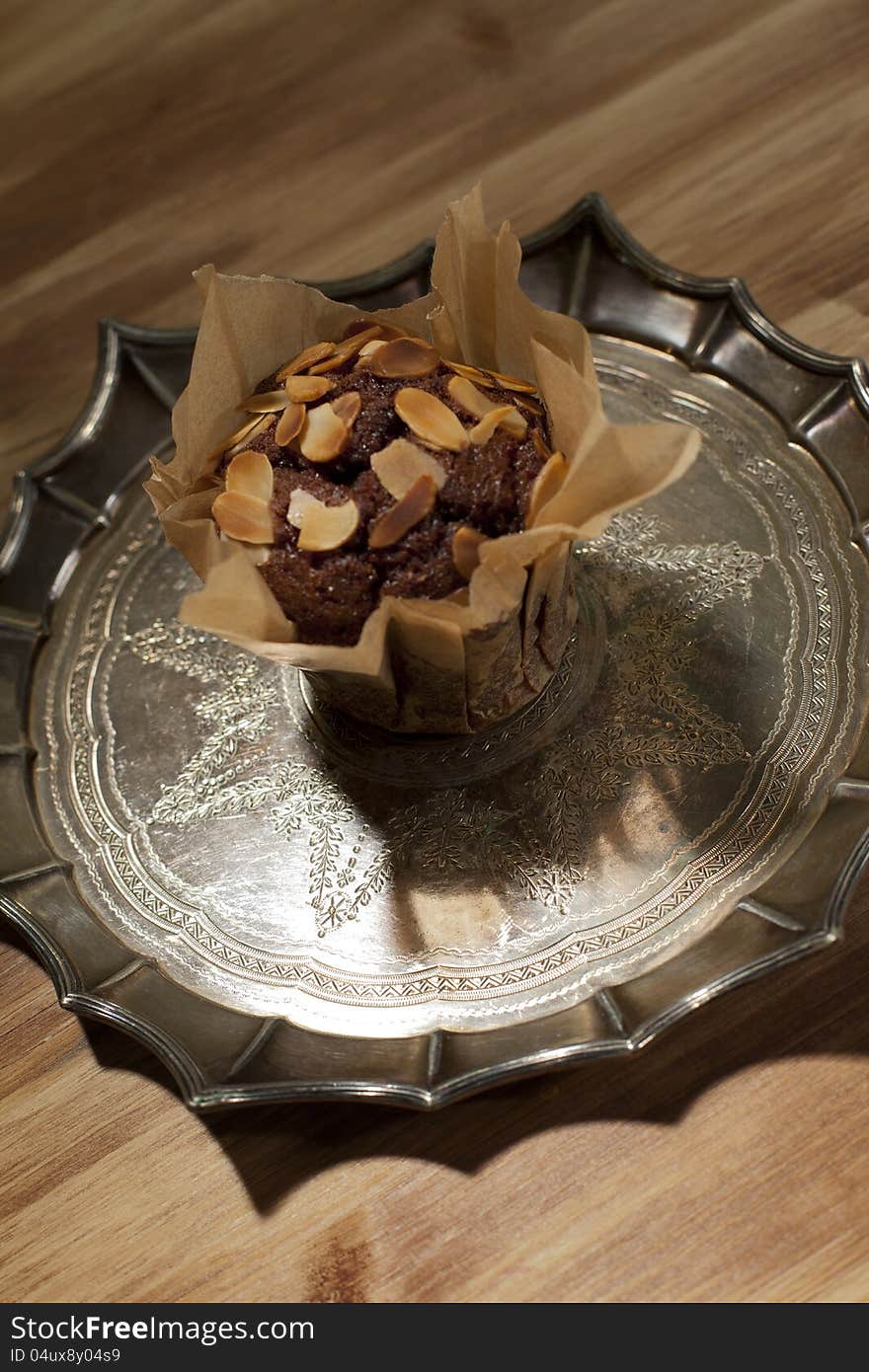 Peanuts with delicious muffin on silver plate. Peanuts with delicious muffin on silver plate