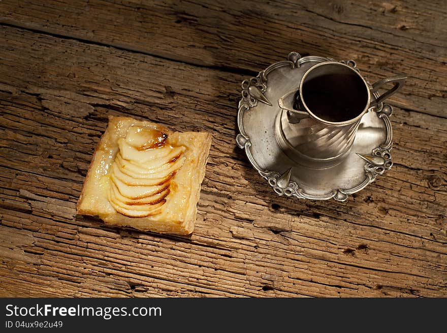 Apple slpastry and silver objects decorating table