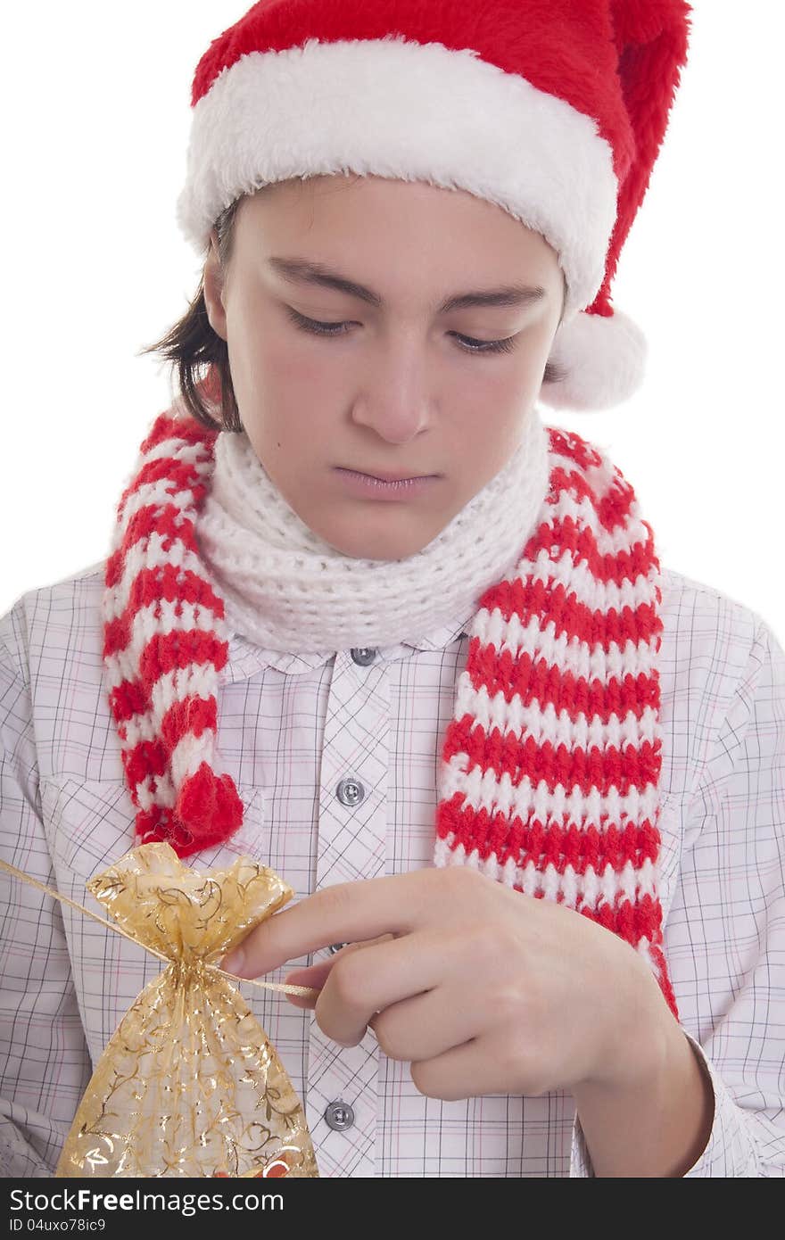 Handsome teenage boy with Christmas hat preparing his present. Handsome teenage boy with Christmas hat preparing his present