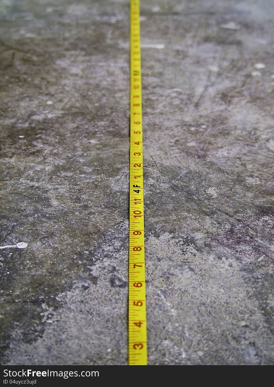 Measuring Tape on Concrete Floo