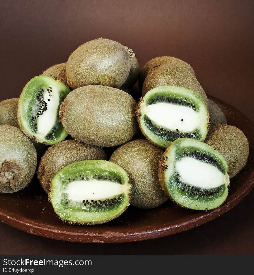 Fresh ripe kiwi in old ceramic plate