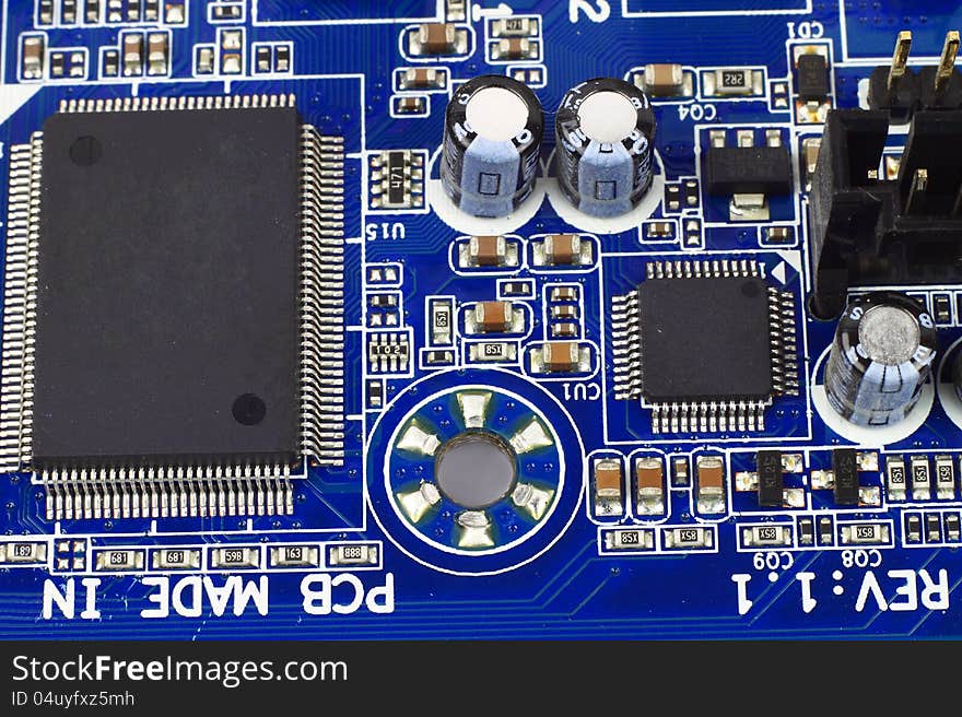 Digital hardware closeup. Microchips and condensers assembly on the circuit board macro. Digital hardware closeup. Microchips and condensers assembly on the circuit board macro