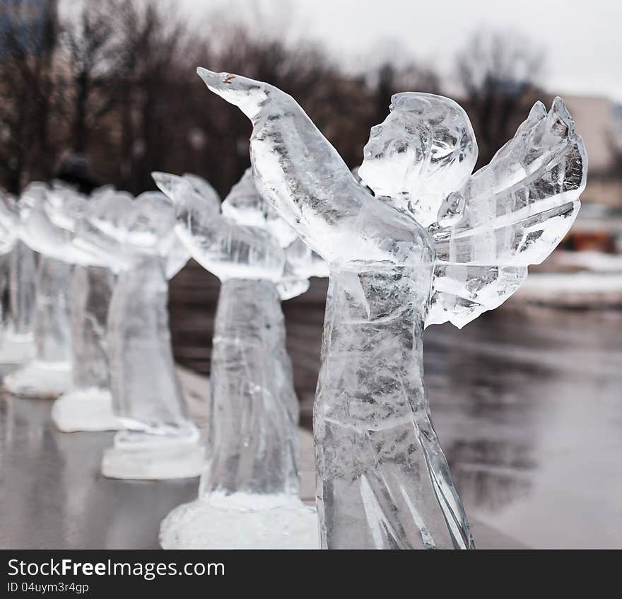 Icy sculpture of frozen angel in winter city. Icy sculpture of frozen angel in winter city