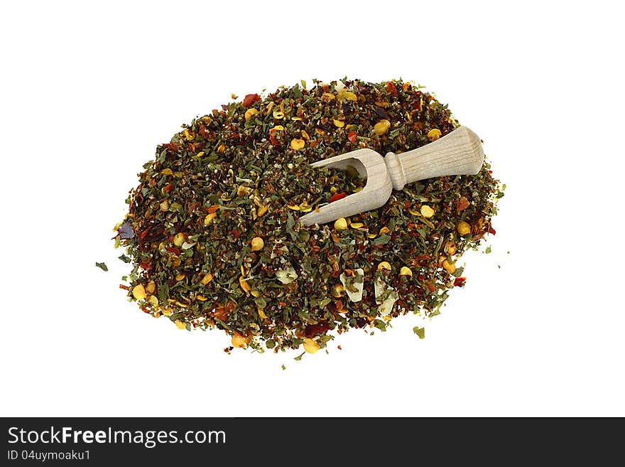 Spices mixture in a pile and scapula isolated on white