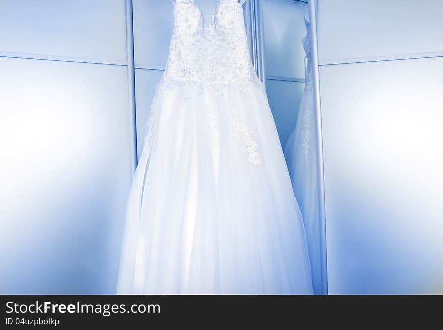 White wedding dress near the mirror