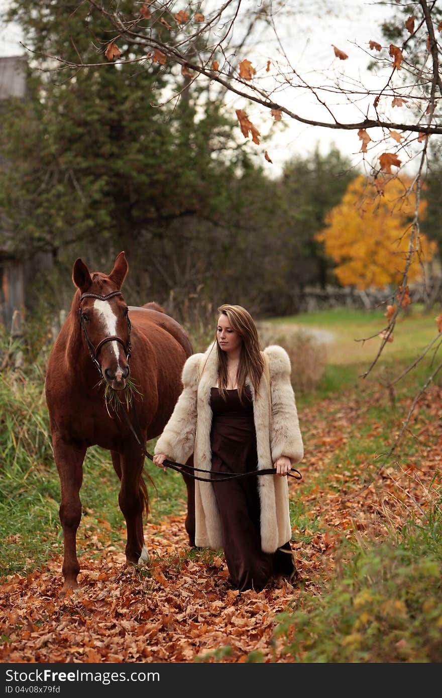 Formal young lady walking her horse