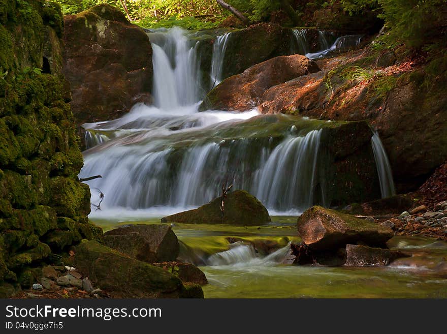 Beautiful forest stream with cascades.