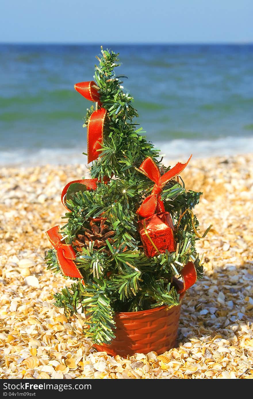 Festively decorated Christmas tree on the beach